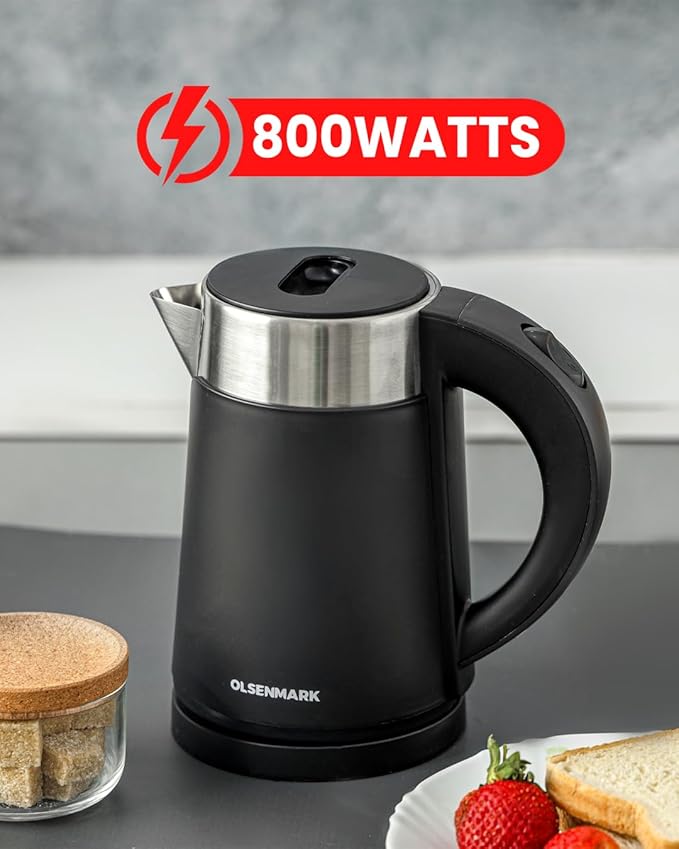 Black electric kettle with 800 watts label on a kitchen counter with food items.